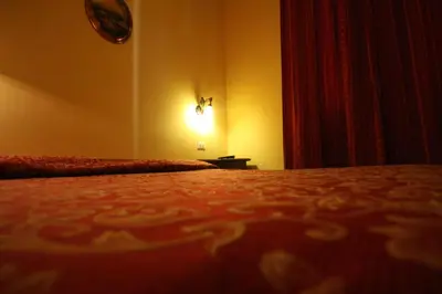 a bedroom with a bed and a clock on the wall at Hotel Cherubini in Rome