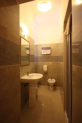 a bathroom with a sink and a toilet at Hotel Cherubini in Rome