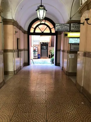 an empty hallway in a building with an archway at Hotel Cherubini in Rome