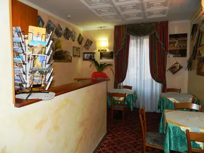 a restaurant with a counter and two tables and chairs at Buonarroti Home in Rome