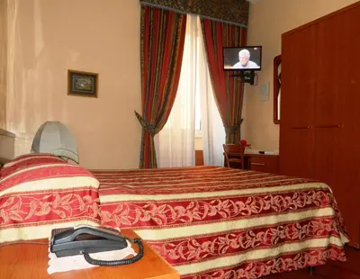a hotel room with a bed with a tv in the window at Buonarroti Home in Rome