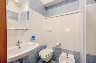 a bathroom with a sink and a toilet at Buonarroti Home in Rome