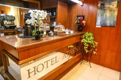 a hotel counter with flowers on top of it at Albergo Athena in Rome