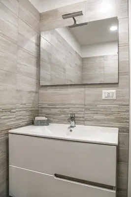 a bathroom with a white sink and a mirror at Albergo Athena in Rome