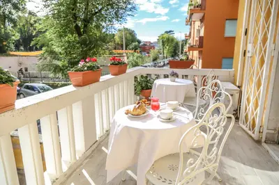 a white table and chairs on a balcony at Albergo Athena in Rome