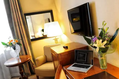 a hotel room with a desk with a laptop on it at LH Hotel Lloyd Roma in Rome