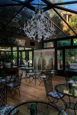 a dining room with a chandelier and tables and chairs at Hotel Villa San Pio in Rome