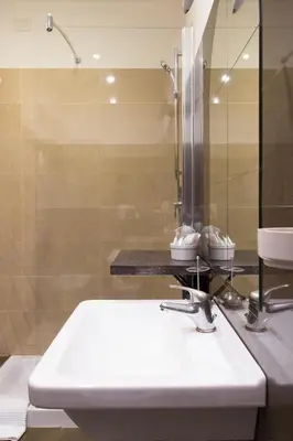 a bathroom with a white sink and a shower at Residenza Ki in Rome