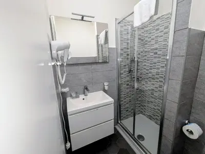 a bathroom with a sink and a shower and a mirror at Residenza Ki in Rome