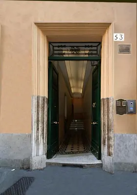 an empty hallway of a building with green doors at Residenza Ki in Rome