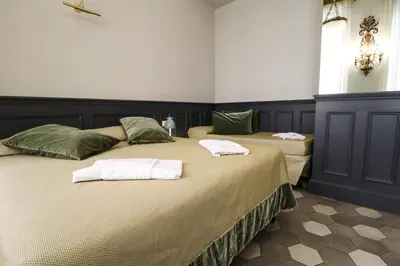 two beds in a bedroom with towels on them at Residenza Ki in Rome