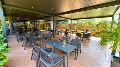 a restaurant with tables and chairs and a patio at Crowne Plaza Rome St. Peter's by IHG in Rome