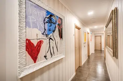 a hallway with a large painting on the wall at Roma Boutique Hotel in Rome