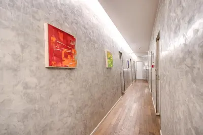 a hallway with two paintings on the wall at Roma Boutique Hotel in Rome