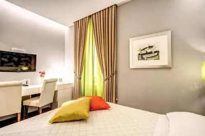 a hotel room with a bed and a desk and a computer at Roma Boutique Hotel in Rome