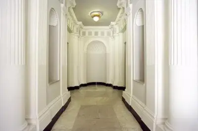 a hallway with white walls and a ceiling at Roma Boutique Hotel in Rome