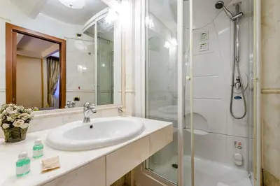 a bathroom with a sink and a shower at Luxury Rooms H 2000 Roma in Rome