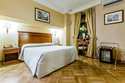 a hotel room with a bed and a window at Luxury Rooms H 2000 Roma in Rome
