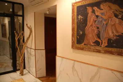 a painting hanging on a wall next to a doorway at Luxury Rooms H 2000 Roma in Rome