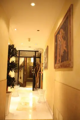 a hallway with a person standing in a doorway at Luxury Rooms H 2000 Roma in Rome
