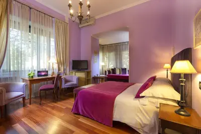 a hotel room with a bed and a desk at Hotel Fenix in Rome