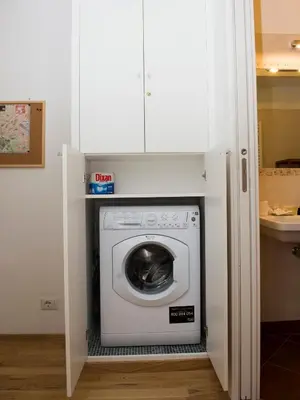 a washer and dryer in a kitchen with a cabinet at Saint Peter Apartment in Rome