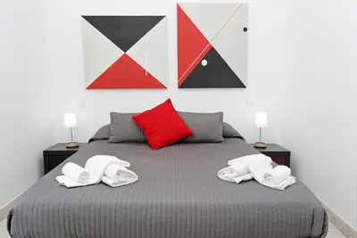 a bedroom with a bed with three pillows on it at Houspitality Nero Bed & Breakfast in Rome