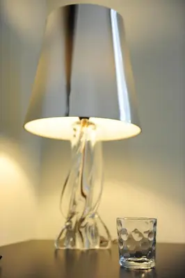 a lamp sitting on a table next to a glass at Houspitality Nero Bed & Breakfast in Rome