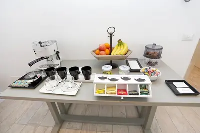 a table with a coffee maker and fruit on it at Houspitality Nero Bed & Breakfast in Rome