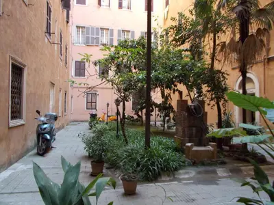 a scooter parked next to a building with trees and plants at Houspitality Nero Bed & Breakfast in Rome