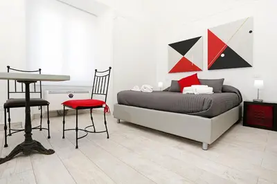 a bedroom with a bed and a table and chairs at Houspitality Nero Bed & Breakfast in Rome
