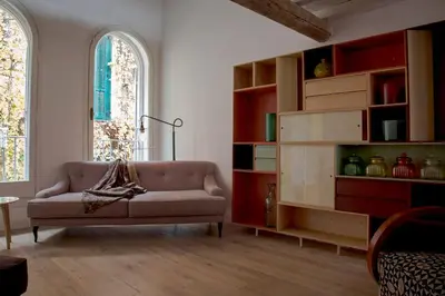 a living room with a couch and a book shelf at Casa Fabbrini Boutique B&B in Rome