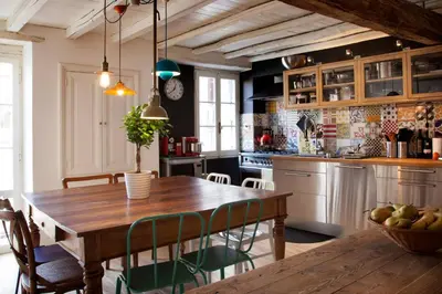 a kitchen with a wooden table and some chairs at Casa Fabbrini Boutique B&B in Rome