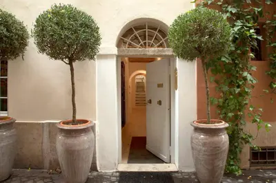 a hallway with two trees in large concrete vases at Casa Fabbrini Boutique B&B in Rome