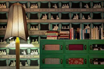 a room with a green cabinet with books and a lamp at Casa Fabbrini Boutique B&B in Rome