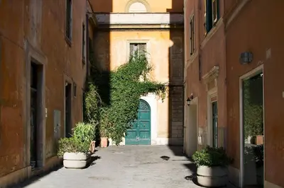an alley with a blue door in a building at Casa Fabbrini Boutique B&B in Rome