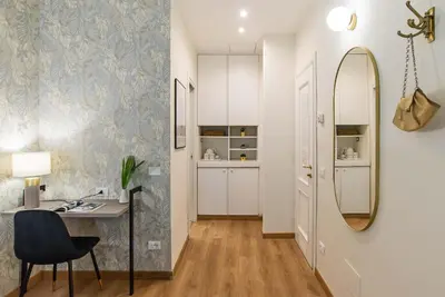 a room with a desk and a mirror at 94Rooms Vatican Guest House- Scipioni in Rome