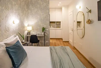 a bedroom with a bed and a desk in a room at 94Rooms Vatican Guest House- Scipioni in Rome