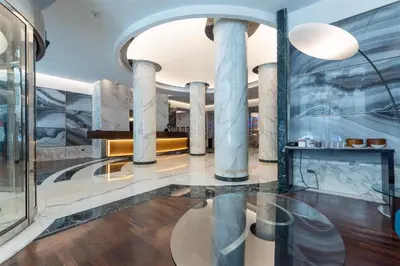 a lobby of a building with columns at Best Western Plus Hotel Universo in Rome