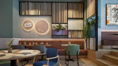 a restaurant with a table and chairs and a dining room at Hilton Garden Inn Rome Colosseum in Rome