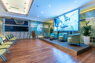 a waiting room with chairs and a large screen at Best Western Premier Hotel Royal Santina in Rome