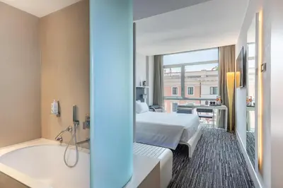a hotel room with a bed and a bath tub at Best Western Premier Hotel Royal Santina in Rome