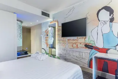 a hotel room with a wall mural of a person at Best Western Premier Hotel Royal Santina in Rome