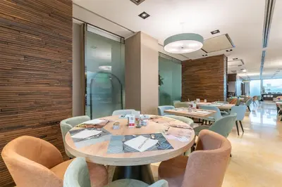 a dining room with tables and chairs at Hilton Garden Inn Rome Claridge in Rome