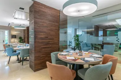 a dining room with a table and chairs at Hilton Garden Inn Rome Claridge in Rome