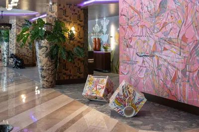 a room with a colorful wall with a large vase at NYX Hotel Rome by Leonardo Hotels in Rome