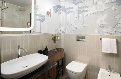 a bathroom with a white sink and a toilet at NYX Hotel Rome by Leonardo Hotels in Rome