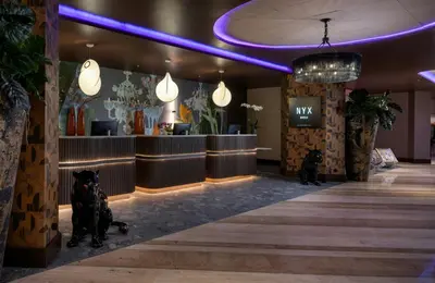a lobby with two dogs sitting in front of a salon at NYX Hotel Rome by Leonardo Hotels in Rome