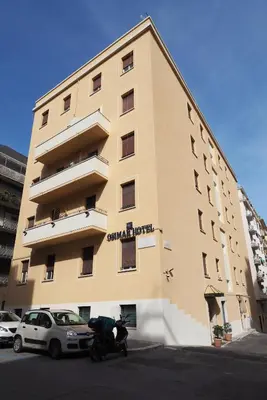 a building with a motorcycle parked in front of it at Hotel Osimar in Rome