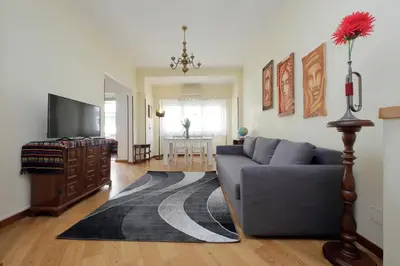 a living room with a couch and a tv at 4BNB - Cipro Vatican Apartment in Rome